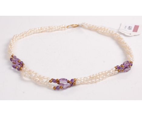 A cultured seed pearl and amethyst set triple string choker