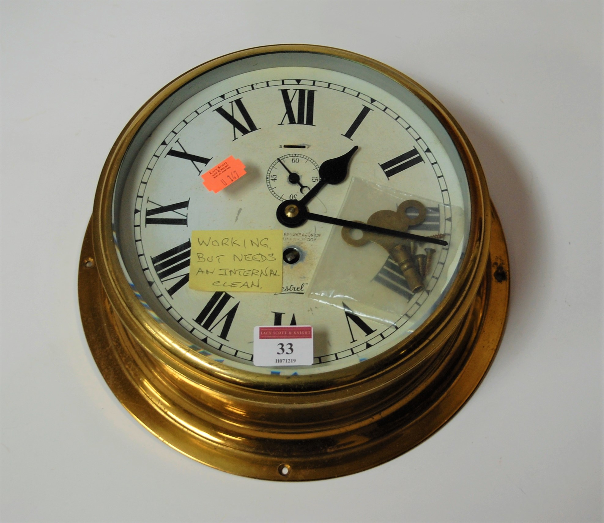 A Sestrel brass cased ships bulkhead clock having a circular enamel ...