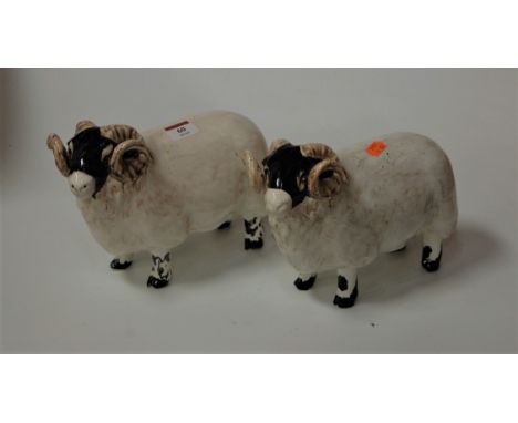 A pair of modern David Sharp ceramic figures of rams, length 24cm