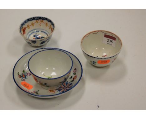 An early 19th century English porcelain tea bowl and saucer, enamel decorated with flowers, possibly Newhall, together with t
