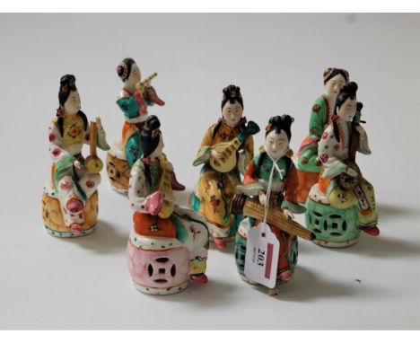 A set of eight continental porcelain figures, each in the form of a seated lady playing an instrument, h.13cm