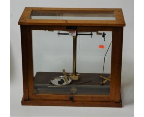 A pair of mid 20th century teak cased chemists scales bearing a label for Griffin &amp; George Ltd, width 46cm