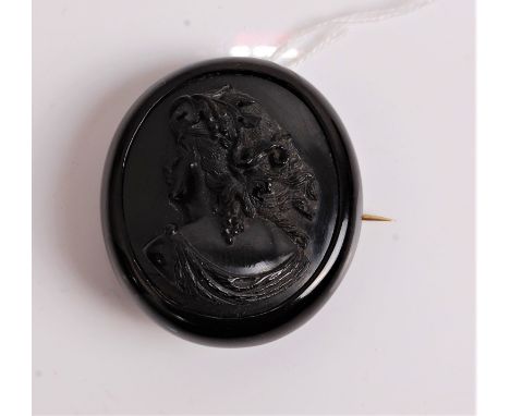A Victorian carved Whitby jet brooch depicting profile portrait of a maiden, 52 x 47mm.Thumbnail crack to bottom left at appr