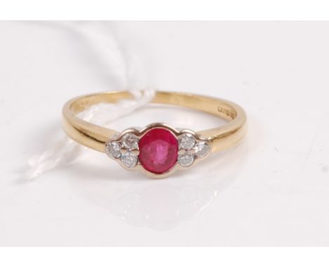 An 18ct gold, ruby and diamond dress ring, arranged as a central oval cut ruby flanked to either side by three diamond highli