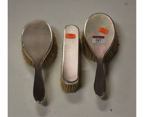 A set of three 1970s silver backed brushes, each with engine turned decoration