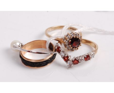A 9ct gold, garnet and cz set wishbone ring; together with a Victorian yellow metal mourning ring set with elephant hair(?); 