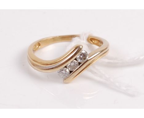 A yellow metal diamond wishbone ring, centre set with three brilliants, total diamond weight estimated approx 0.27ct, unmarke