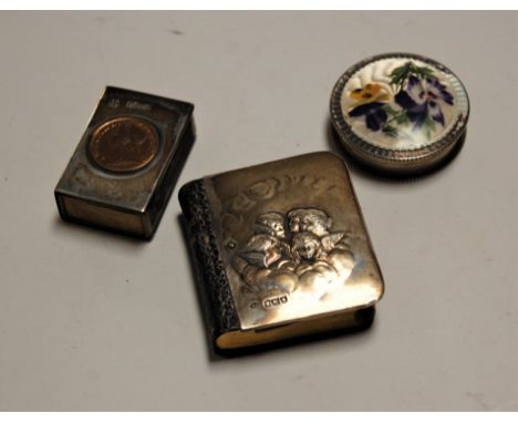 An Edwardian silver clad miniature book of prayer, the front cover relief decorated with putti, maker William Comyns; togethe