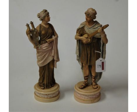 A pair of circa 1900 continental porcelain figures of musicians, each in standing pose, him with a lute in hand, her with a h