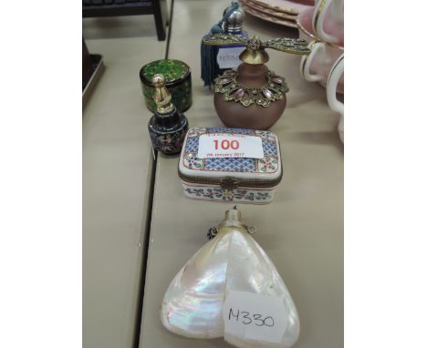 A collection of perfume bottles and trinket boxes including mother of pearl