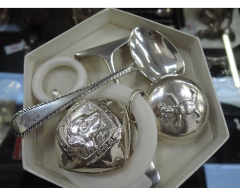 A silver and composite baby's rattle having teddy bear repousse decoration, Birmingham 1947, Hampton Utilities, another simil