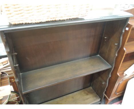 A mid 20th century dark stained book shelf