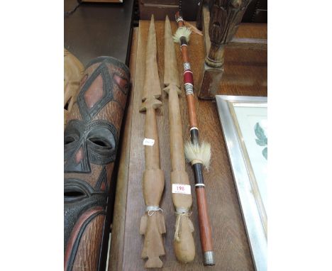 Two tribal carved spears and a decorated ethnic stick