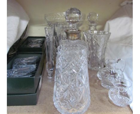 A silver topped decanter together with other glasswares