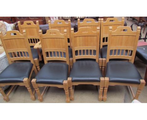 A set of eight light oak and leather upholstered dining chairs