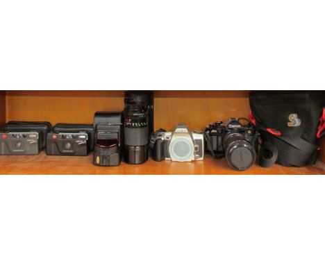 A Leica Mini 35mm camera together with a Leica Mini II, a Minolta DNYAX 505Si, A Canon A-1 35mm camera, lenses etc