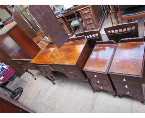 A walnut bedroom suite comprising a triple wardrobe, dressing table, tall boy and bed, together with another bed and two waln