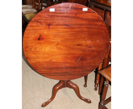 A George III mahogany tripod table, with a circular top on a snap action, baluster column and three splayed legs