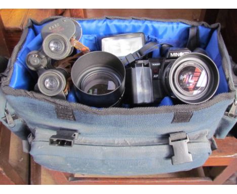 A Minolta 7000 35mm camera together with lenses, case and a pair of binoculars