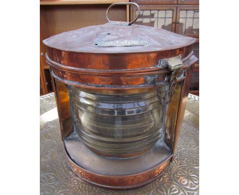 A copper starboard lamp together with two wicker baskets and a cast iron fork 
