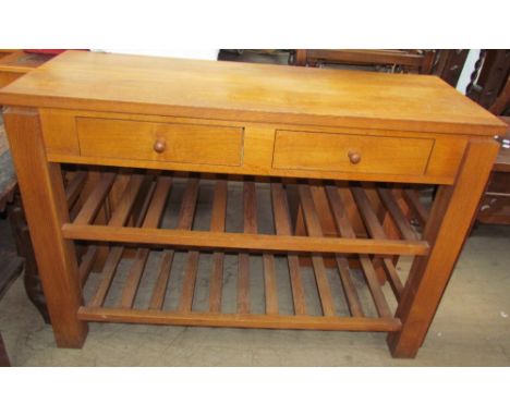 A 20th century oak side table with a pair of drawers on square legs united by slatted racks