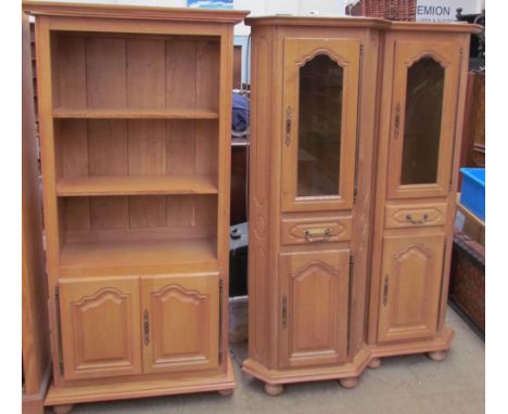 A pair of light oak corner cupboards together with a television cabinet, DVD cabinet and bookcase