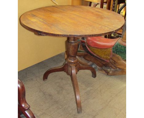 An Elm topped tripod table with a circular planked top and baluster turned column on a tripod base