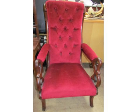 A Victorian rosewood library chair, with a button upholstered back and pad upholstered seat and arms on splayed legs