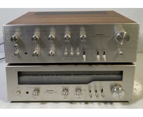 A Rotel RA-612 stereo amplifier and a Rotel RT-824 stereo tuner. Both power on.