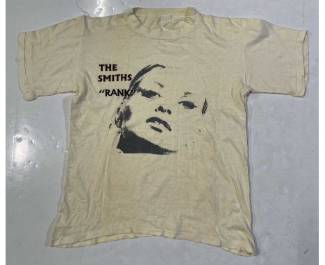 A vintage 1980s t-shirt with 'Rank' print. Good condition. Sizing label illegible. From a large collection of original and vi