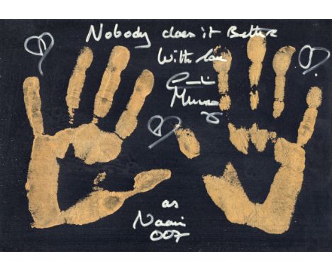 007 James Bond movie The Spy Who Loved Me 8x12 inch card with the left and right personally applied hand prints in gold with 