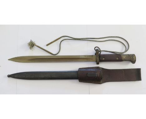 An Eastern Block Bayonet with unmarked 30cm blade and scabbard stamped tgf E95 (CROSSED SWORD EMBLEM) 50 