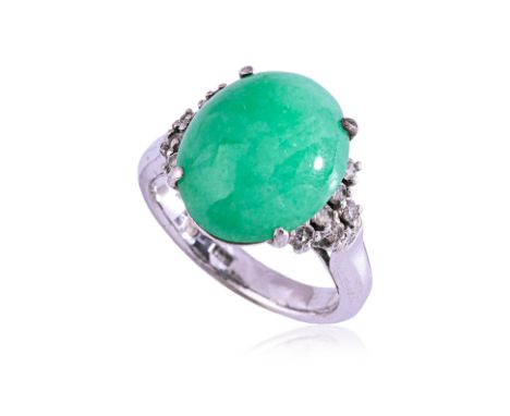 A JADE AND DIAMOND RING
Featuring a jade cabochon mounted in a white gold setting marked '18K', accented with round single cu