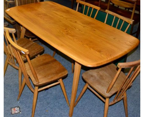 An Ercol light elm dining table 