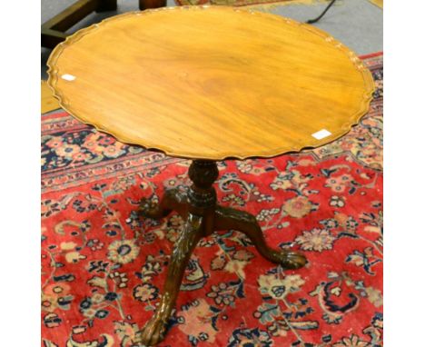 A 19th century mahogany tilt top tripod table, with pie crust top and ball and claw feet