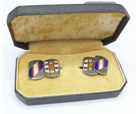 A pair of silver and enamel cufflinks 