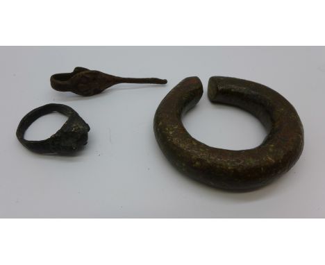 A Tibetan bronze ring, a clip and a heavy fabric ring 