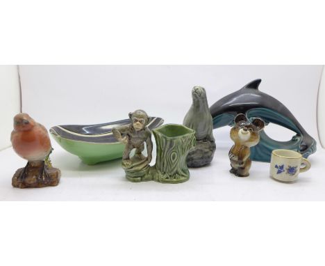 A USSR Olympics mascot figure, a Wade chimpanzee posy vase, a Poole dolphin, a Beswick seal decanter and Robin figure, etc., 