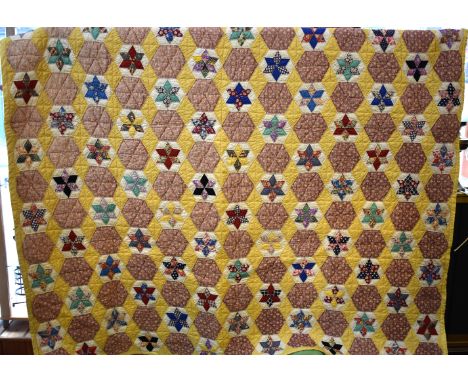 Quilt - This yellow back quilt has the same pattern other in this collection, yellow diamonds separate hexagons some of which