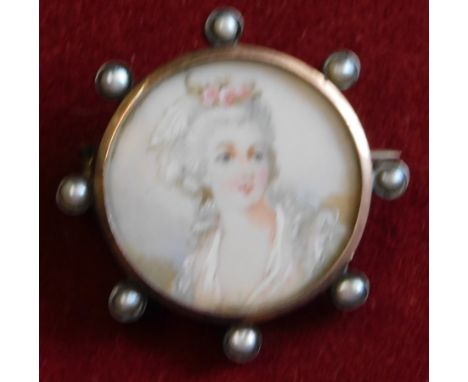 Miniature Portrait brooch 2.5cm with round white metal frame having inset pearls, hand painted on porcelain depicting a 18th 
