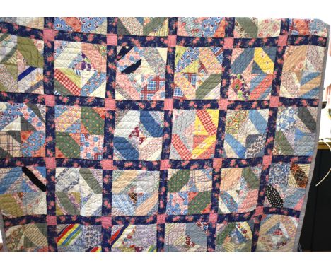 Quilt - The pattern is that of four squares in a large square divided by sashings and posts, the quilt is homely, and the wad