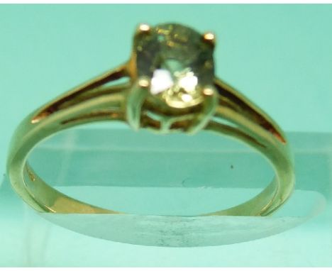 Two 9ct gold rings set with peridot and another 9ct gold ring