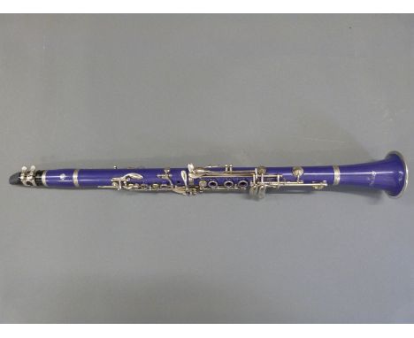 A cased Cecilio clarinet in purple composite finish