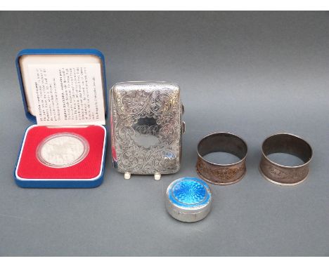 A hallmarked silver cigarette case, guilloche enamel pill box, 1977 coin and pair of napkin rings, weight 126g