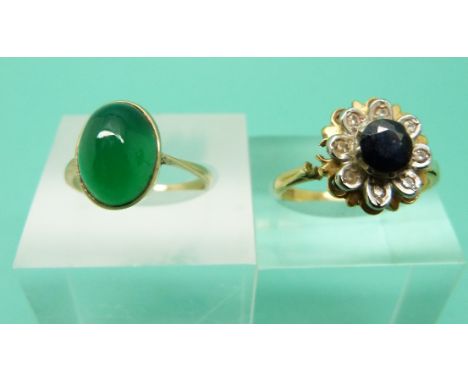 An 18ct gold ring set with a sapphire surrounded by diamonds and a 9ct gold ring set with a green cabochon 