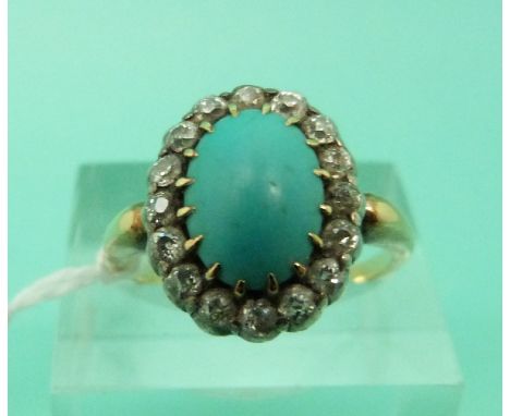 A Victorian 18ct gold ring set with a turquoise cabochon surrounded by old cut diamonds (size O)