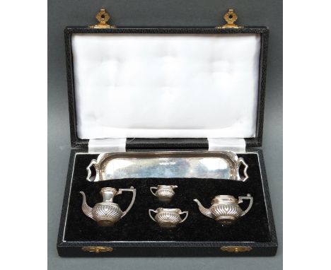 A miniature or doll's hallmarked silver tea service in original case, London 1976 maker Crisford & Norris Ltd, length of tray