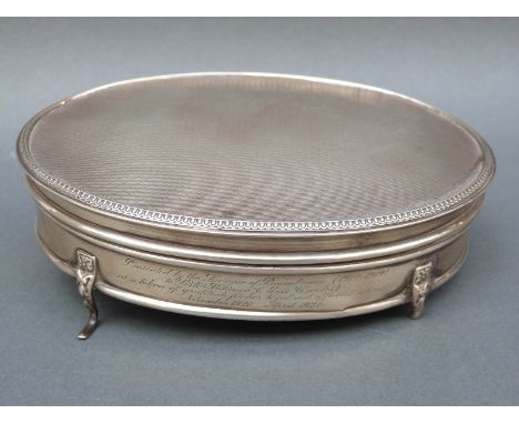 A George V hallmarked silver oval dressing table pot with engine turned lid and gilt interior to lid, Birmingham 1923, maker 