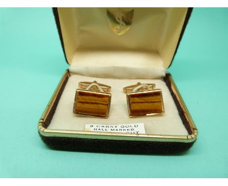 A pair of 9ct gold cufflinks set with tigers eye, 10g. 
