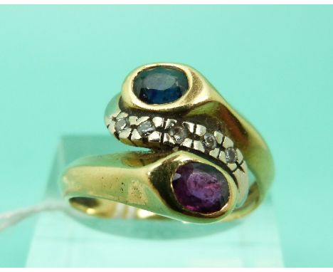 A yellow metal ring set with a sapphire and a ruby with diamonds between them in a twist setting (Size S)